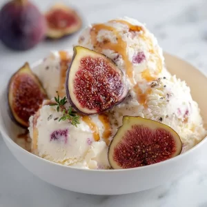 Creamy fig and ricotta ice cream in a bowl with fresh figs